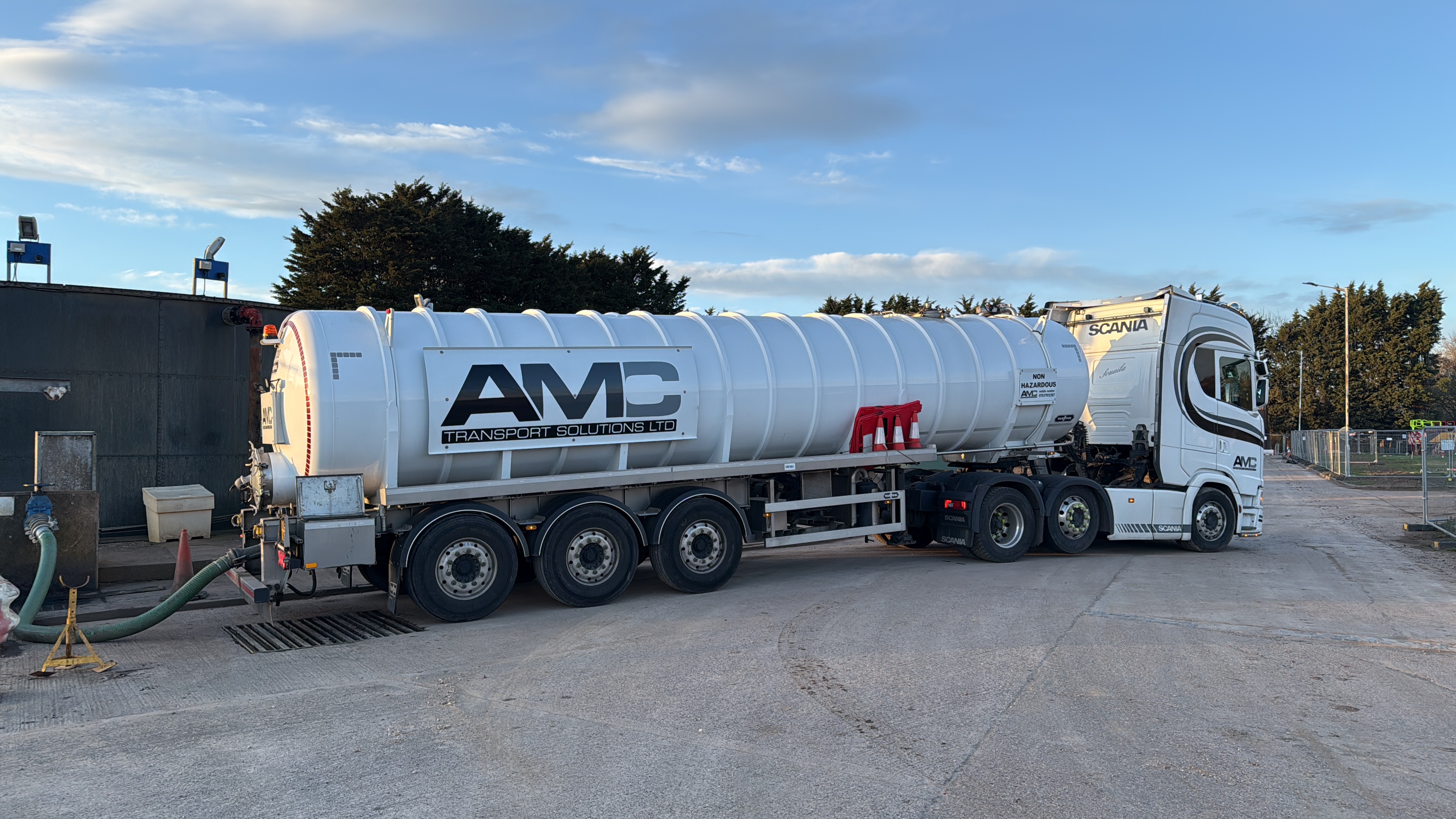 AMC Transport waste management tanker collecting industrial liquid waste