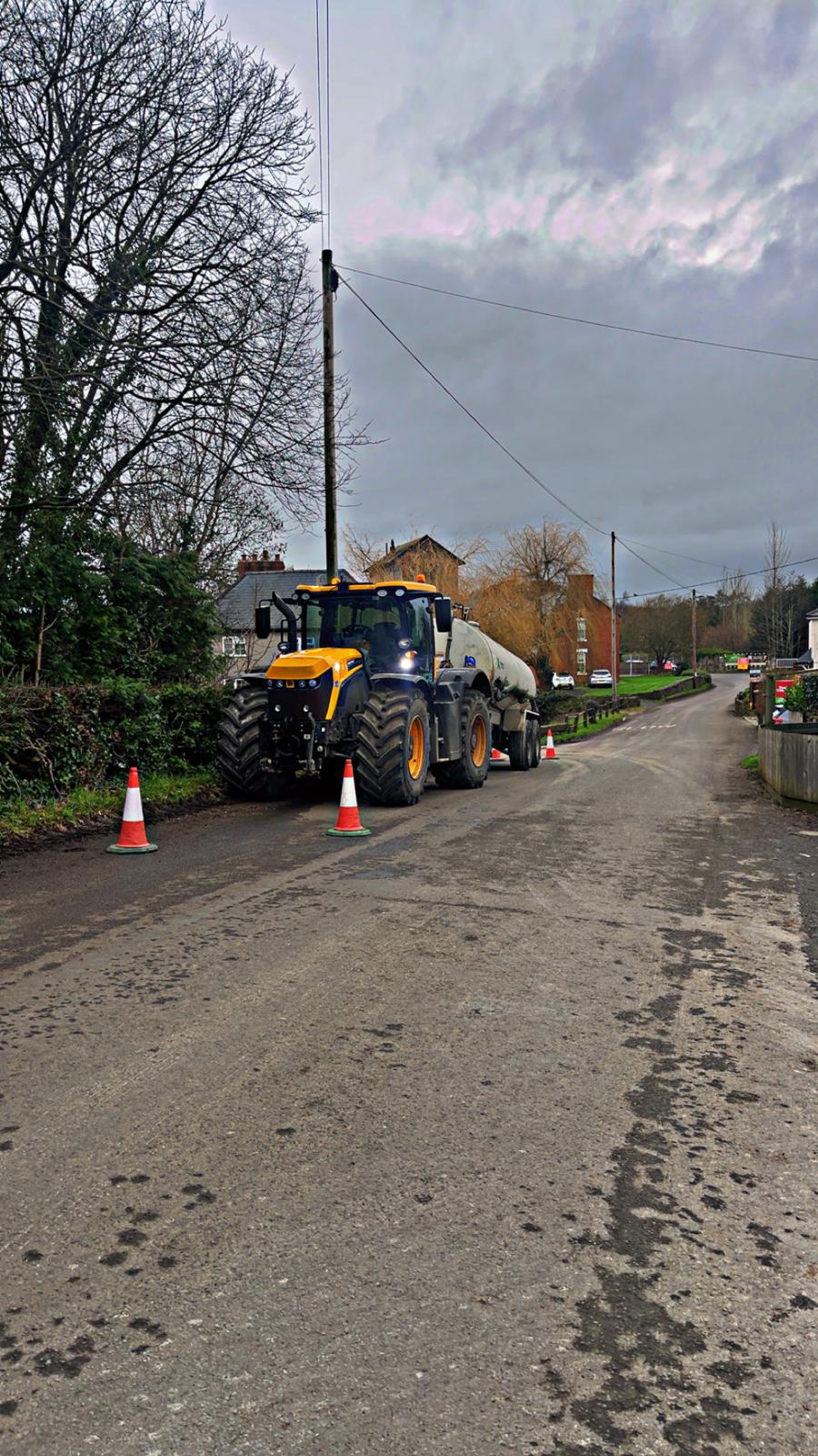 AMC tractor bowser with bowser on village road