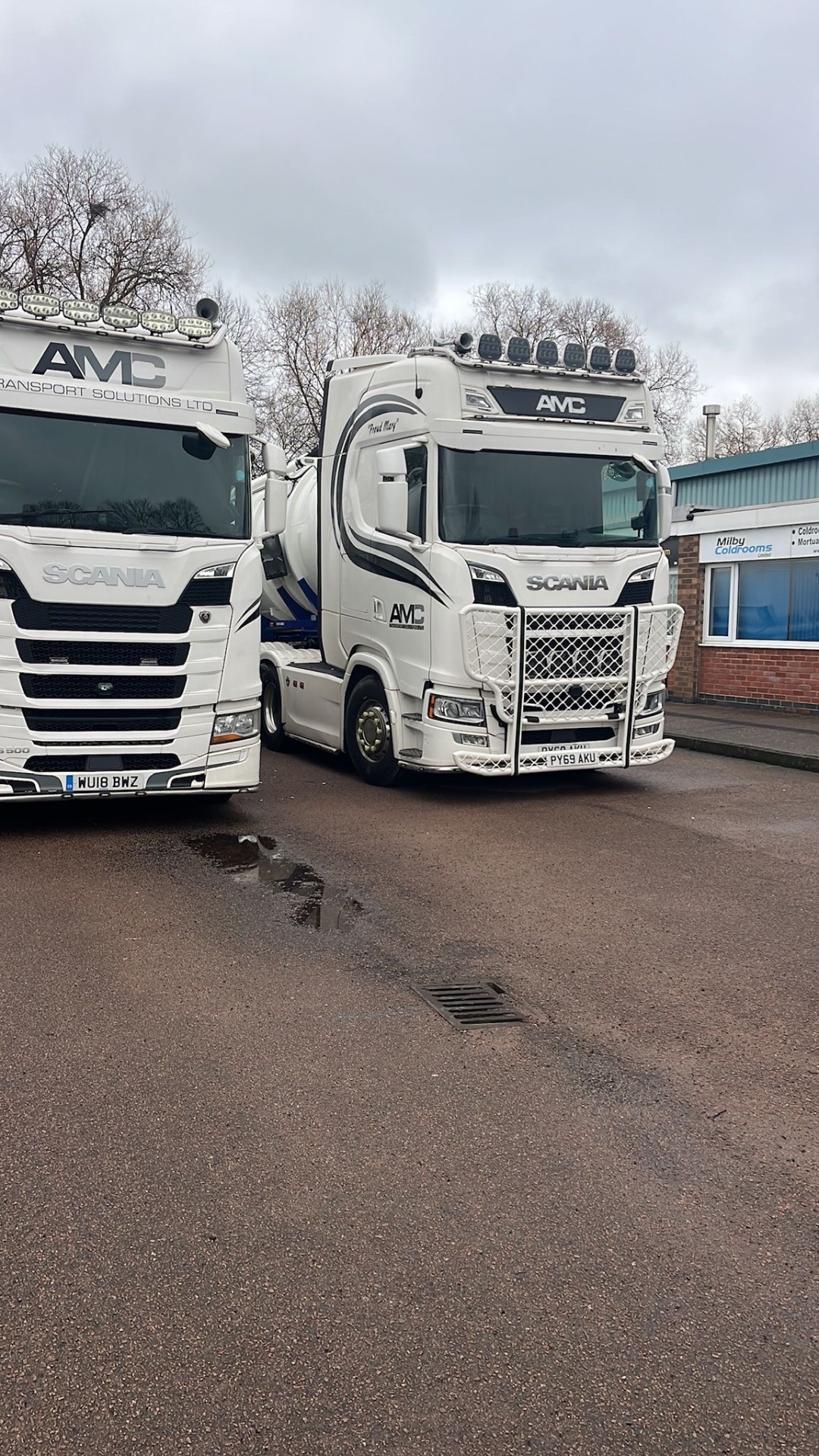 Two AMC Scania trucks